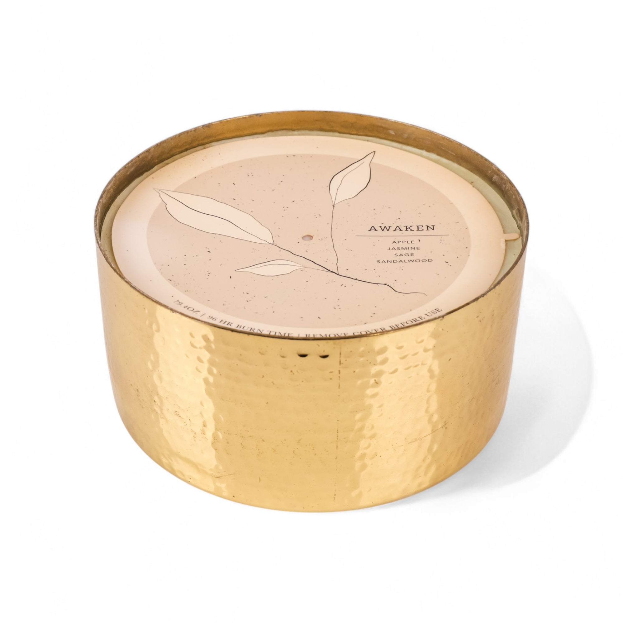 Gold candle container with beige lid featuring leaf design and &#39;Awaken&#39; text on a white background
