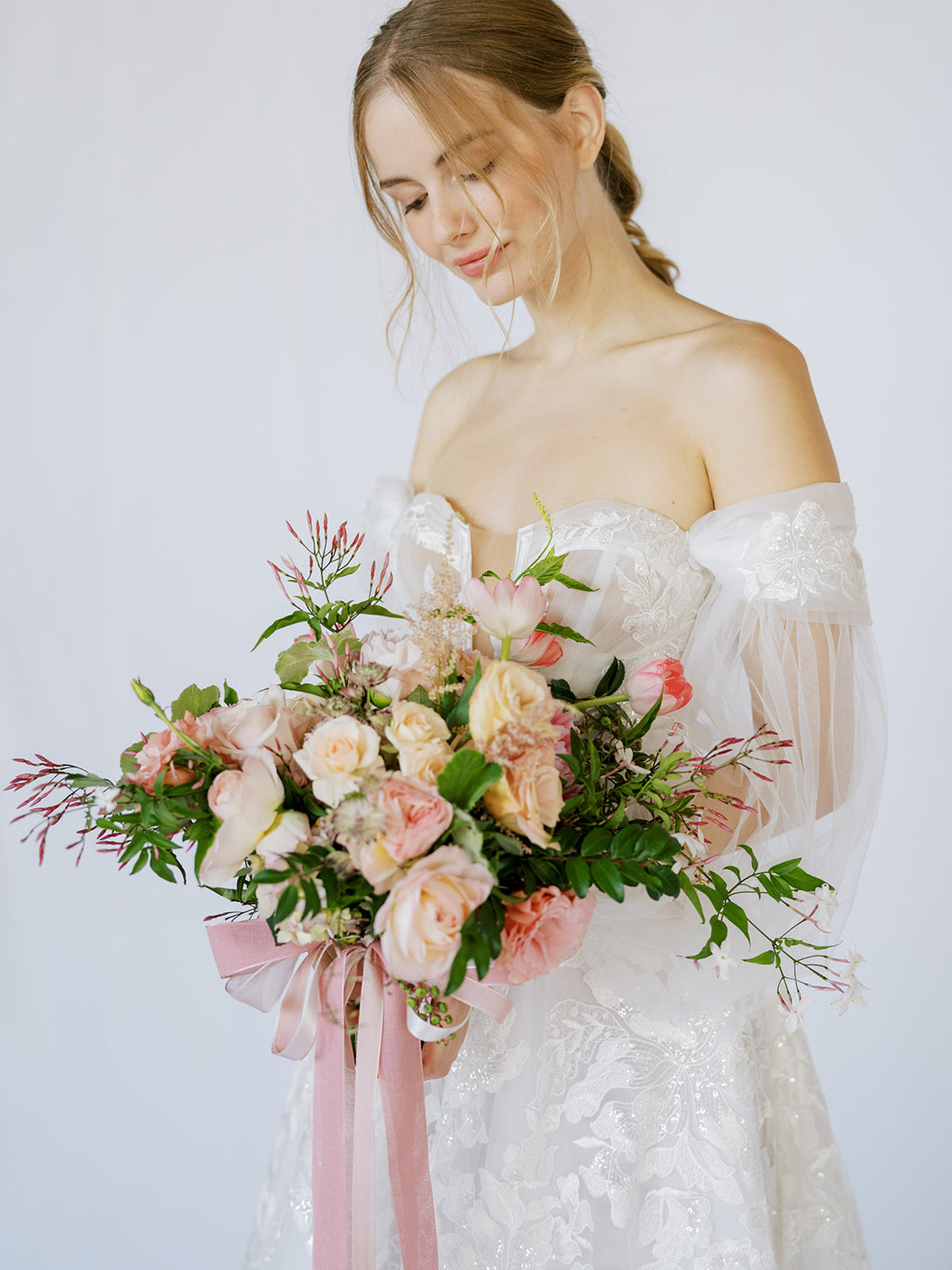 Bride looking down on the Blush A la Carte Wedding Bridal Bouquet from Green Fresh Florals + Plants