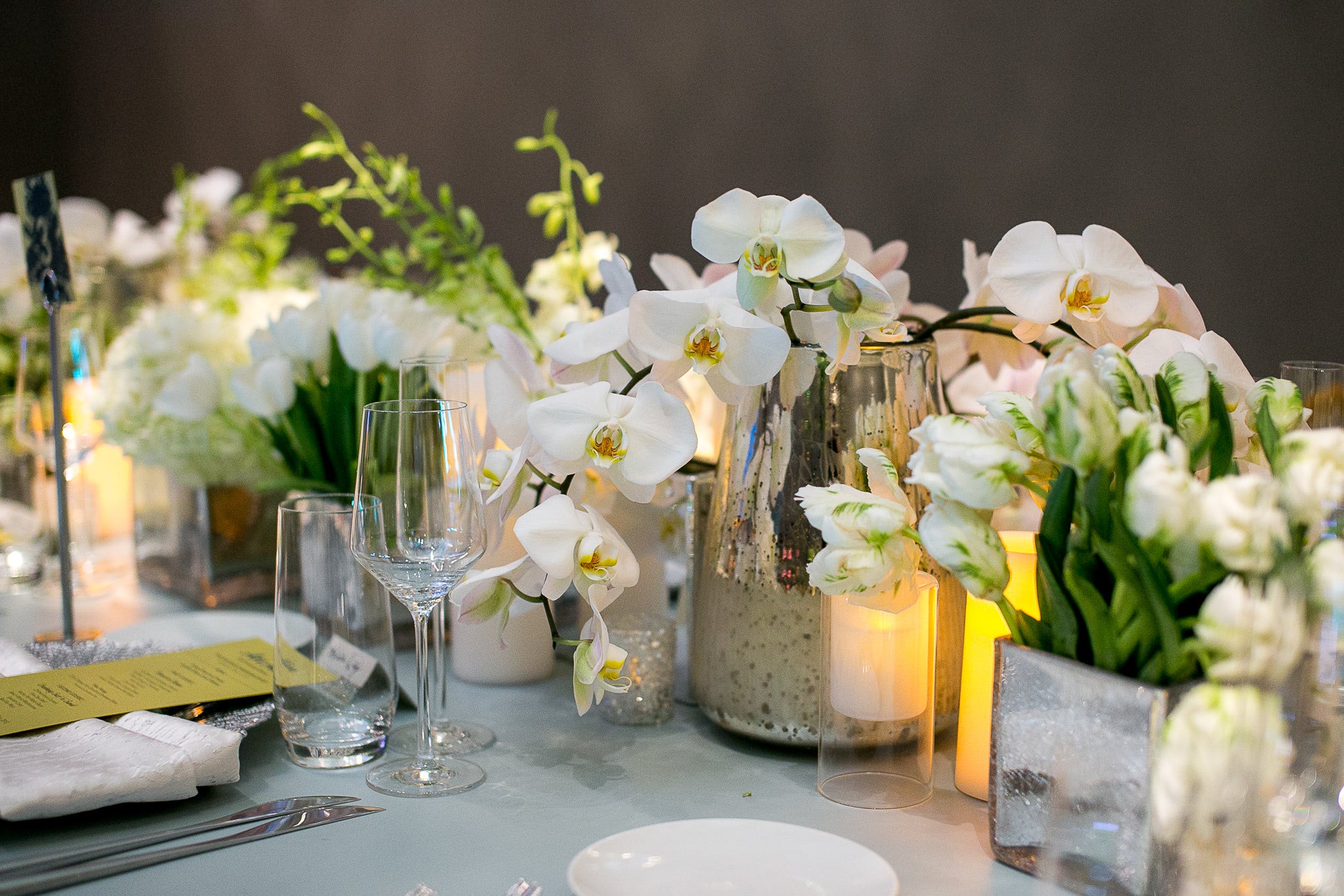 Table of White Flowers in Gold and Silver Vases